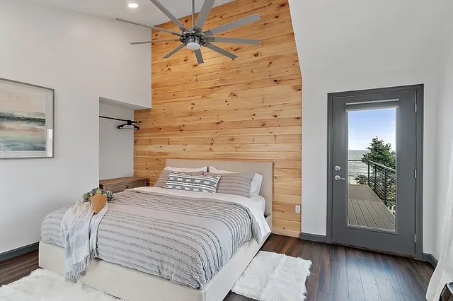 a bedroom with a bed and a potted plant