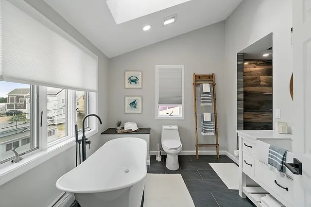 a very nice looking room with a large window and white walls