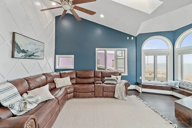 a living room with furniture and large windows