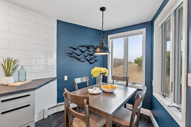 a view of a dining room with furniture window and wooden floor