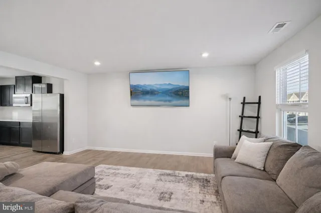 a living room with furniture window and a refrigerator