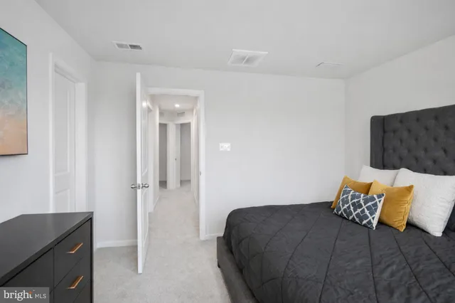 a bedroom with a bed and a dresser