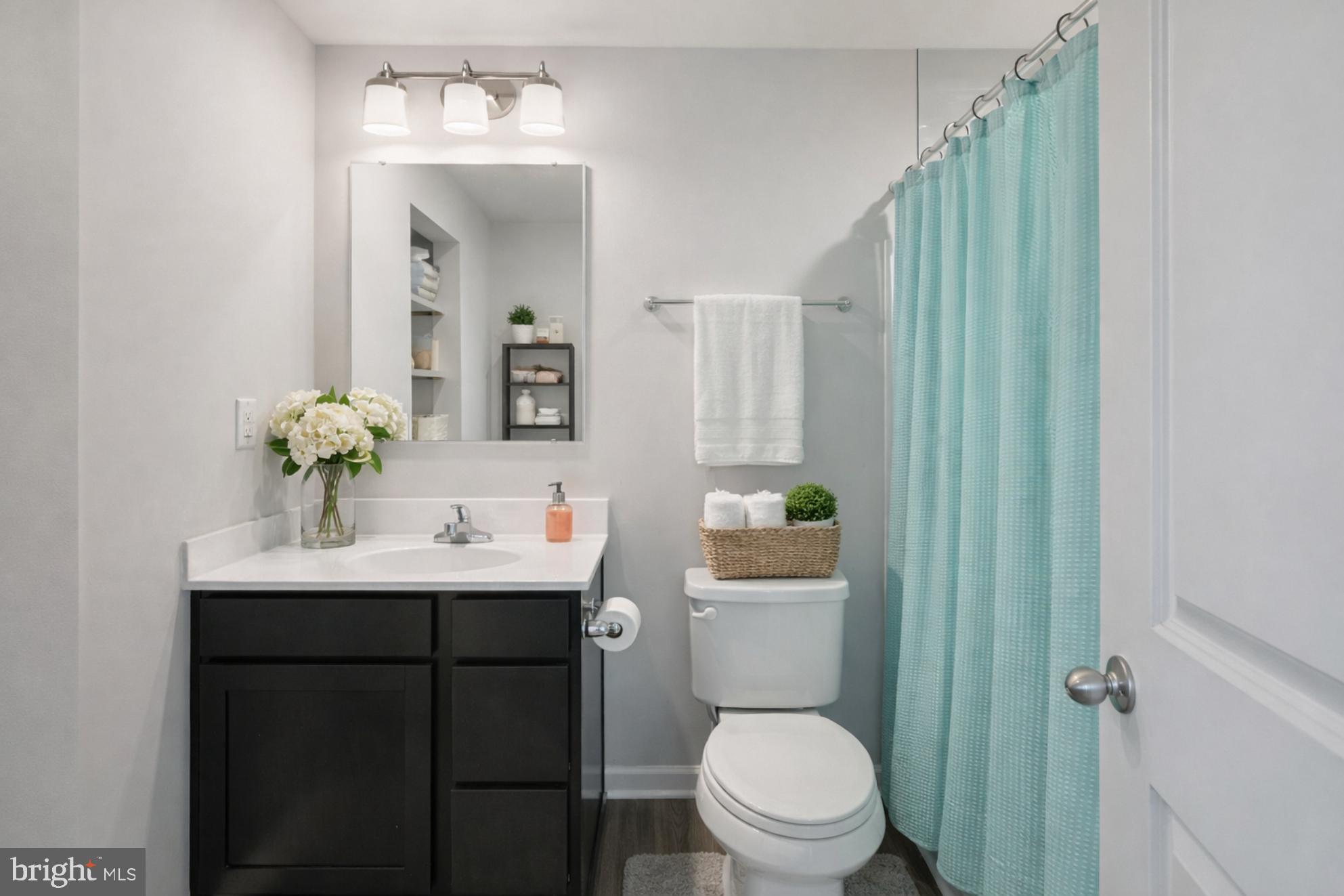 21 Mulberry Lane Clementon, NJ 08021 - Photo 22 of 39 a bathroom with a toilet a sink and mirror
