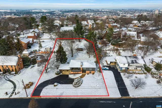 a view of a house with snow on the road