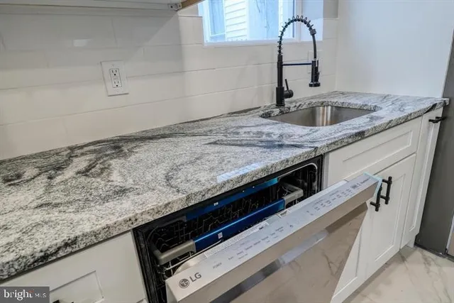 a close view of a sink a faucet and appliance in the kitchen