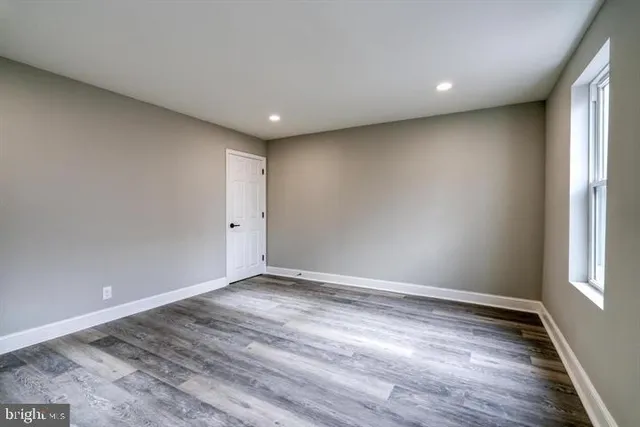 a view of room with window and wooden floor