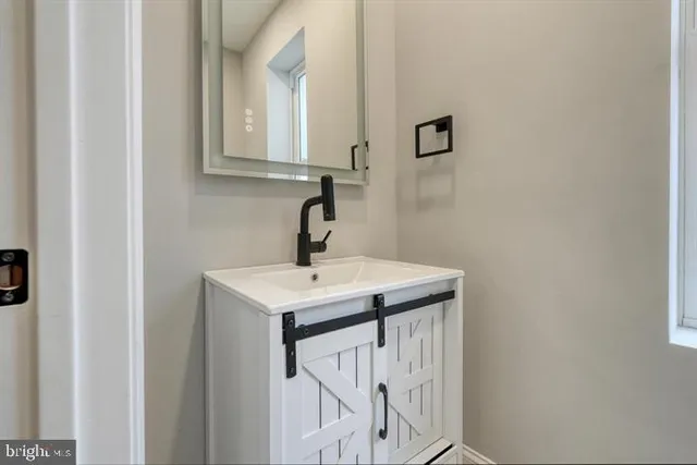 a bathroom with a sink and mirror
