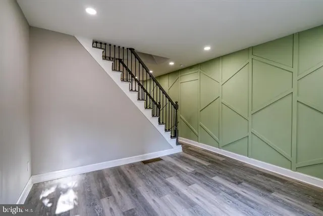 a view of entryway and hall with wooden floor
