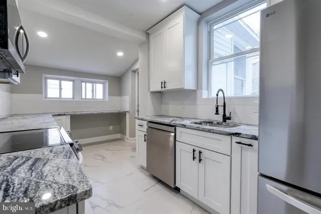 a kitchen with a stove and white cabinets