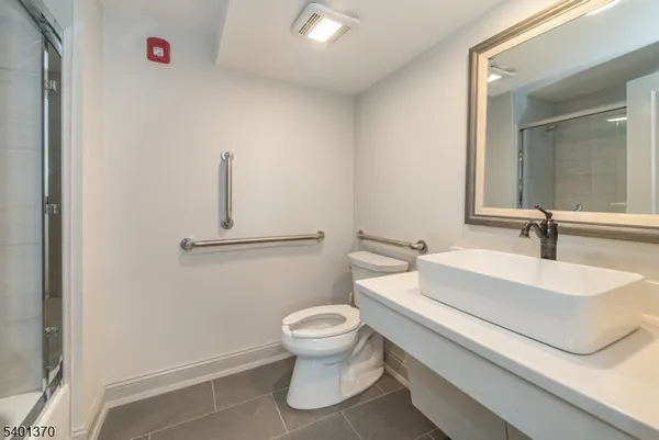 a bathroom with a sink a toilet and a mirror