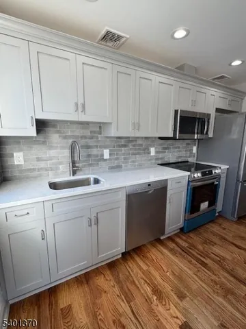 a kitchen with stainless steel appliances granite countertop a sink and cabinets