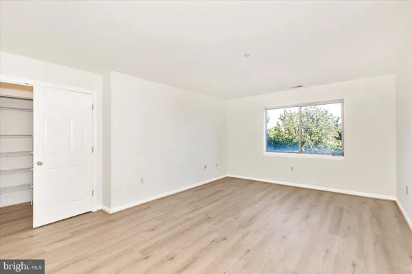 a view of a livingroom with wooden floor and a window