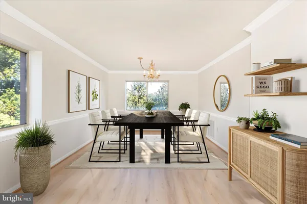 a view of a hallway with wooden floor and entryway