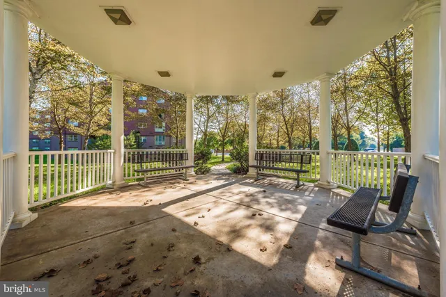 a living room with furniture and floor to ceiling window