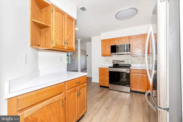 an empty room with wooden floor and fireplace
