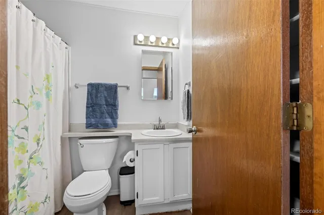 a white toilet sitting next to a bathroom sink