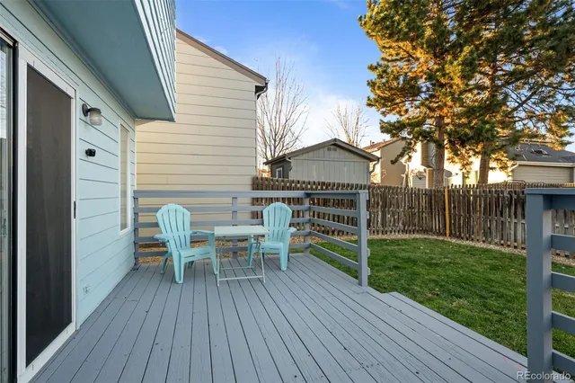 a view of a chair and table on the wooden deck