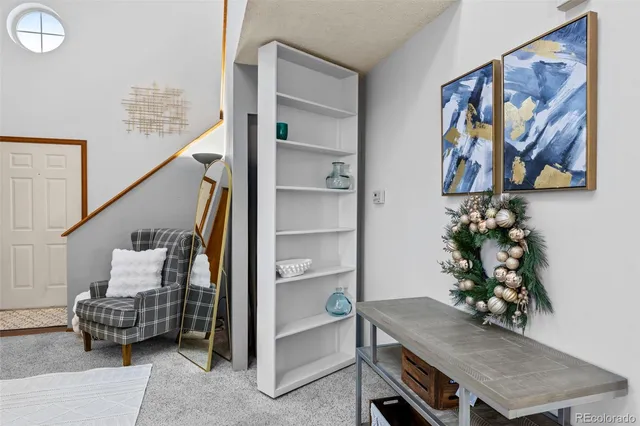 a dining room with furniture and a window