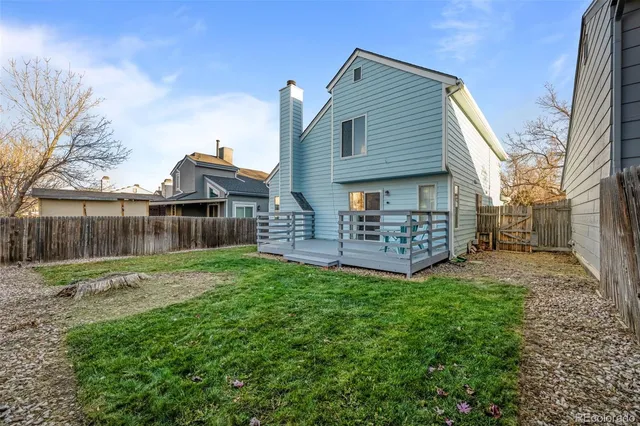 a view of backyard with a garden and deck