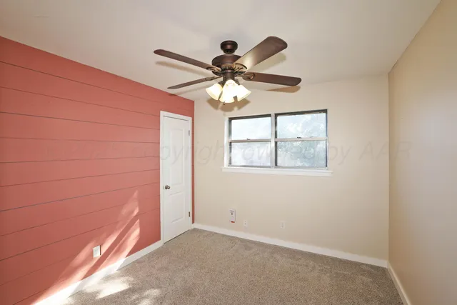 a view of a livingroom with a ceiling fan and window