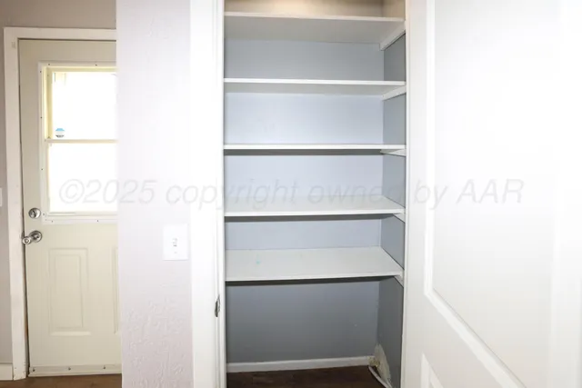 a closet with rack on the wall