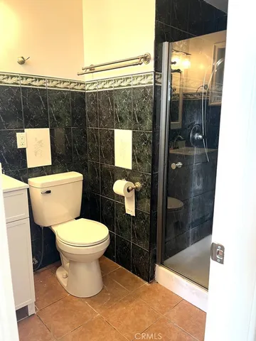 a bathroom with a toilet and a shower