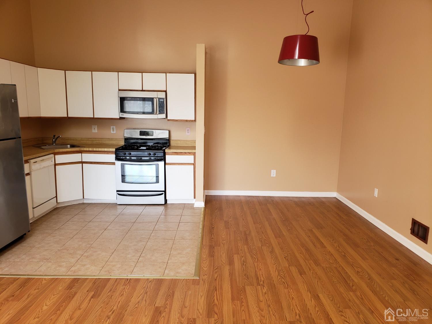 351 Wimbeldon Court North Brunswick, NJ 08902 - Photo 2 of 17 a kitchen with stainless steel appliances a stove top oven and cabinets