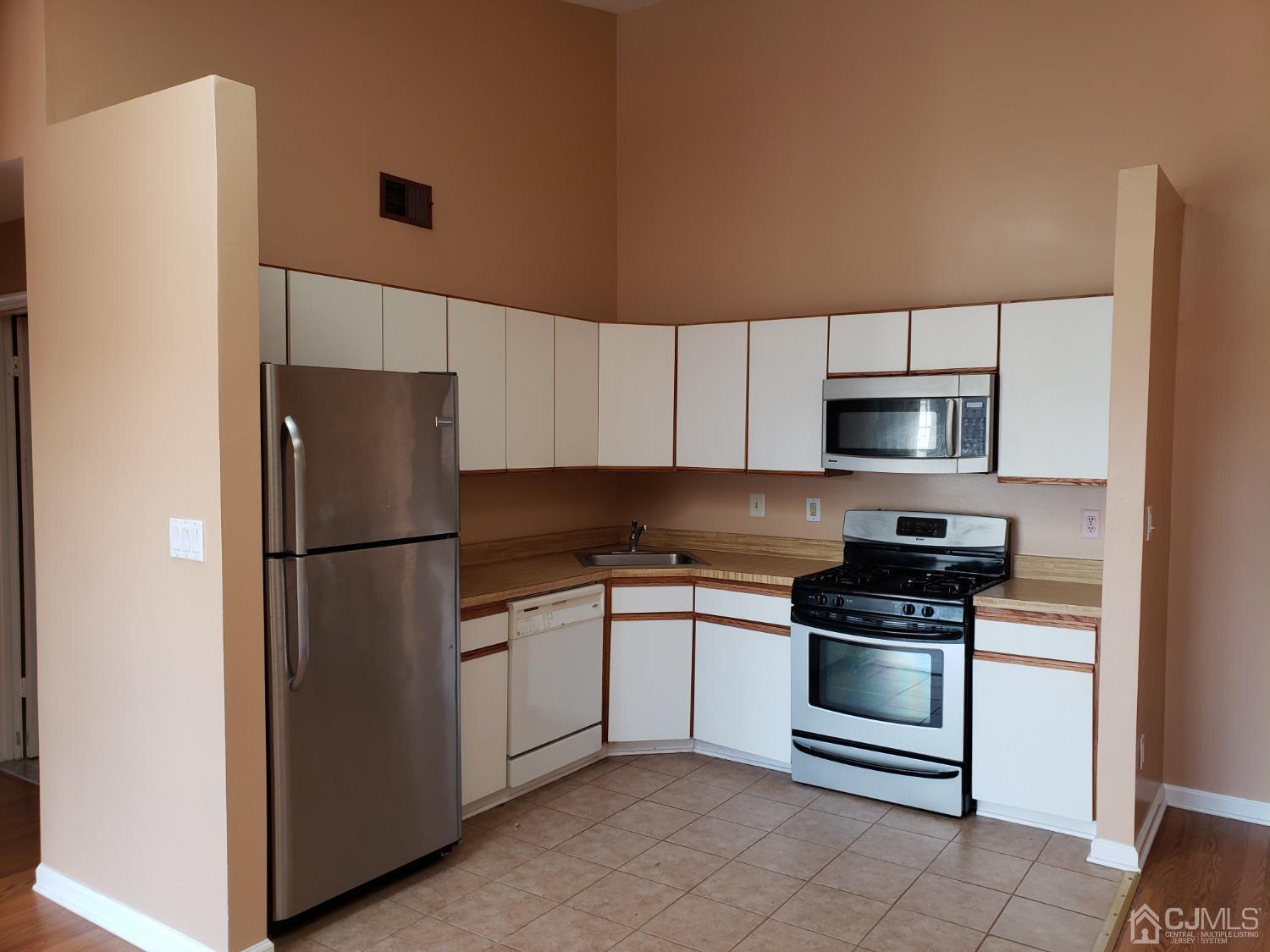351 Wimbeldon Court North Brunswick, NJ 08902 - Photo 4 of 17 a kitchen with stainless steel appliances a refrigerator sink and microwave