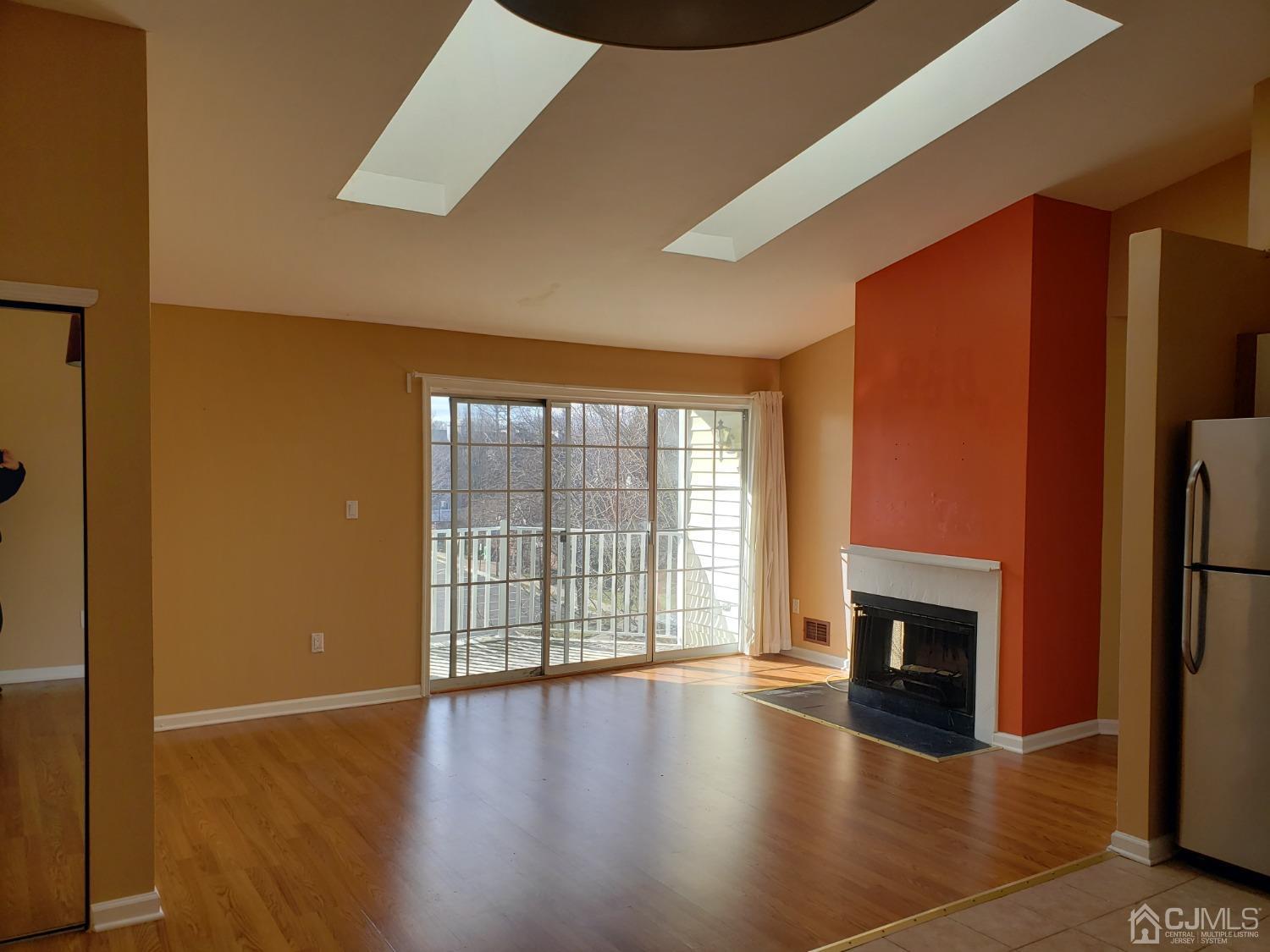 351 Wimbeldon Court North Brunswick, NJ 08902 - Photo 6 of 17 a view of an empty room with window and wooden floor