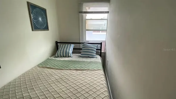 a bedroom with a bed and wall painting