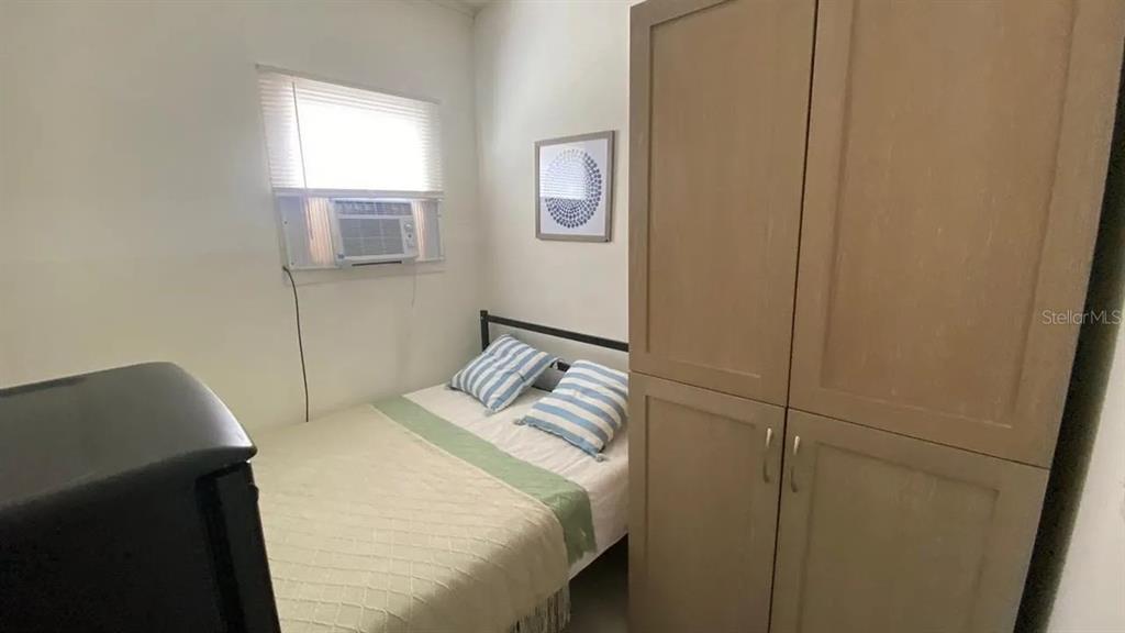 4427 Raleigh Street Orlando, FL 32811 - Photo 15 of 31 a bedroom with a bed and a window