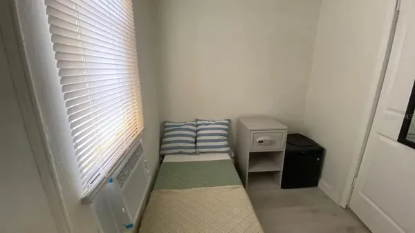 a bedroom with a bed and a mirror