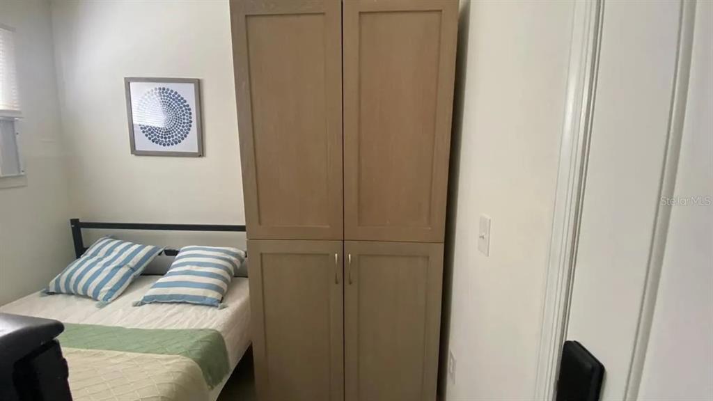 4427 Raleigh Street Orlando, FL 32811 - Photo 21 of 31 a view of walk in closet with clothes and shoes