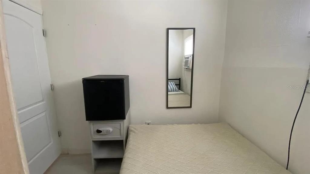 4427 Raleigh Street Orlando, FL 32811 - Photo 24 of 31 a room with a bed and furniture