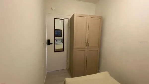 a view of a hallway with wooden floor and a window