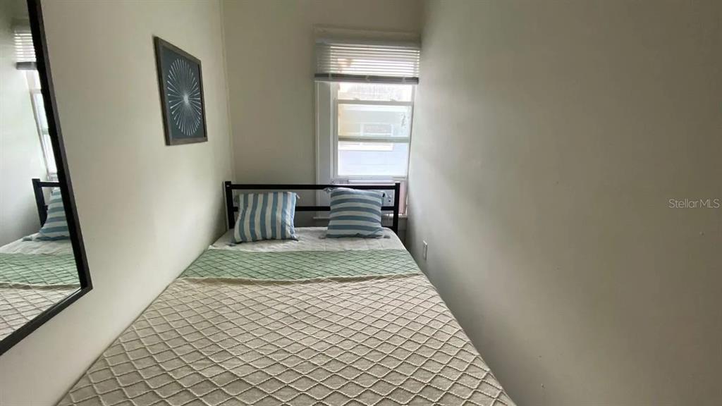4427 Raleigh Street Orlando, FL 32811 - Photo 29 of 31 a view of a hallway with wooden floor and a window