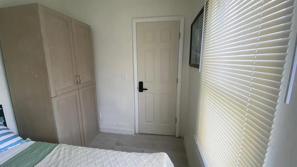 4427 Raleigh Street Orlando, FL 32811 - Photo 31 of 31 a bedroom with a bed and a mirror