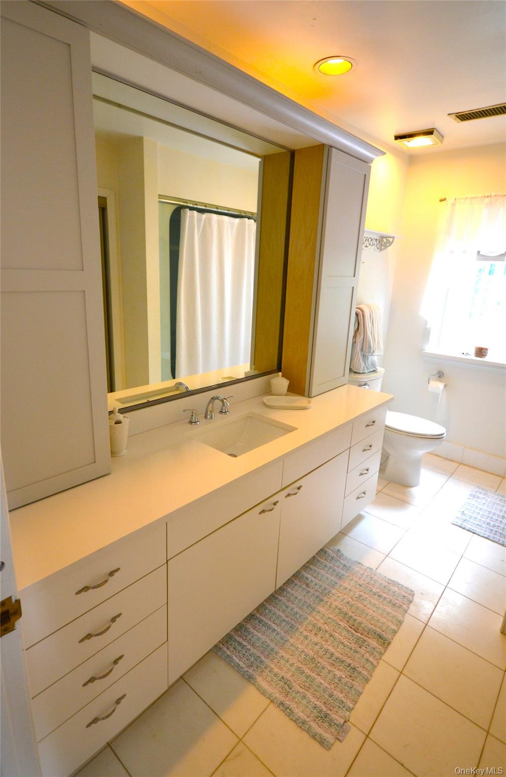 266 Shear Hill Road Mahopac, NY 10541 - Photo 18 of 34 a bathroom with a sink a mirror and a toilet