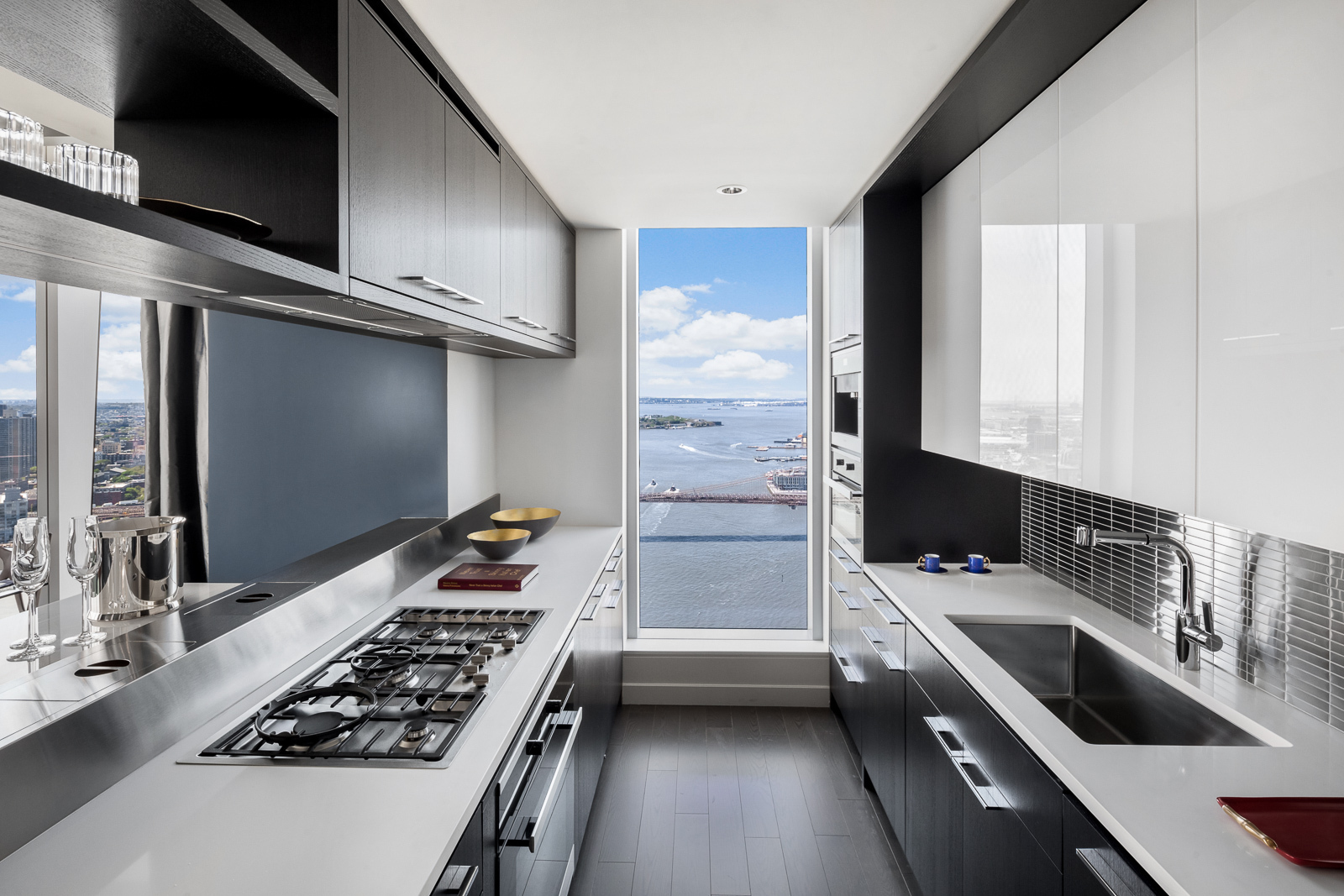 252 South Street, Unit 68C Manhattan, NY 10002 - Photo 4 of 70 a kitchen with stainless steel appliances kitchen island a stove and a sink