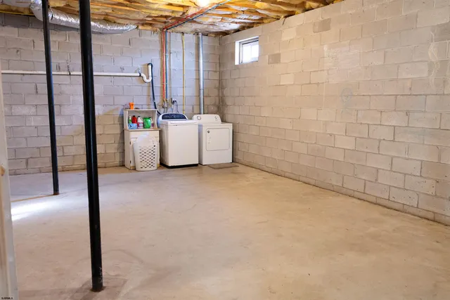 a bathroom with a bathtub shower sink and mirror