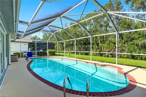 a view of a backyard with swimming pool