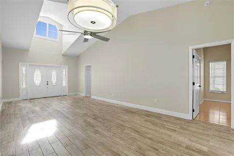 a view of a room with wooden floor and glass door