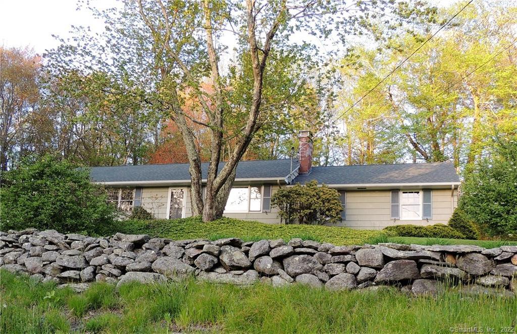 Scenic location with stone wall, extensive shrubs, many flowers, and a variety of ground cover. New roof and gutters installed June 2018
