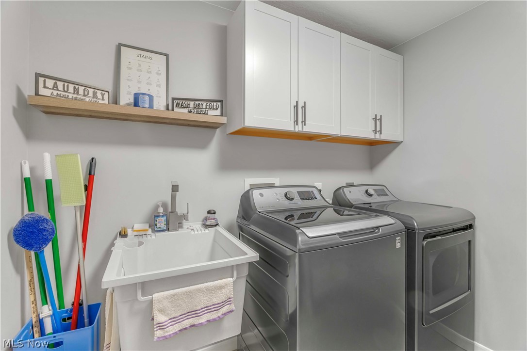 28340 Center Ridge Road, Unit 124 Westlake, OH 44145 - Photo 15 of 37 Laundry area with independent washer and dryer and cabinet space