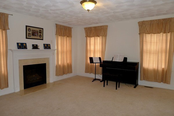 117 Tyler Road Townsend, MA 01469 - Photo 7 of 11 a living room with furniture and a fireplace