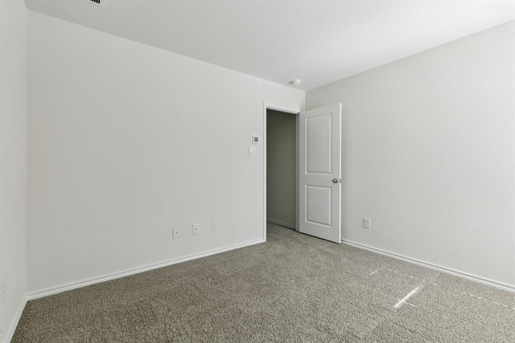 317 Clematis Street Princeton, TX 75407 - Photo 18 of 38 Empty room with carpet flooring and baseboards