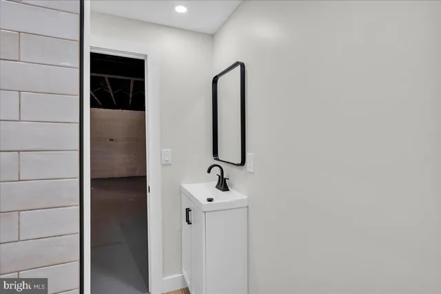 a bathroom with a sink and mirror