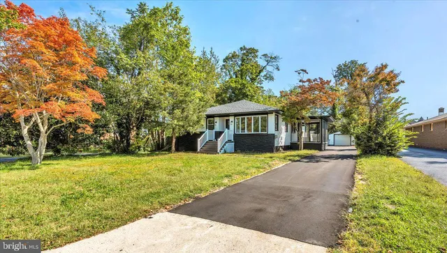 a view of a house with backyard and a tree