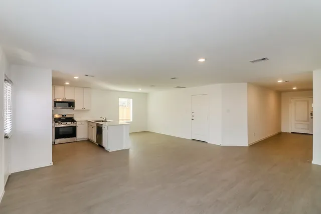a view of a kitchen with refrigerator and microwave