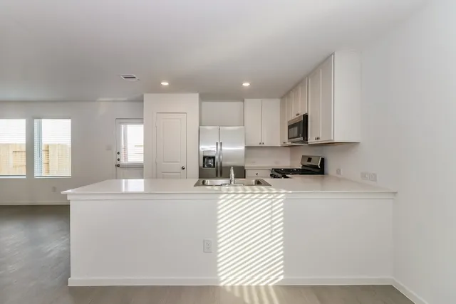 a kitchen with counter top space cabinets and appliances